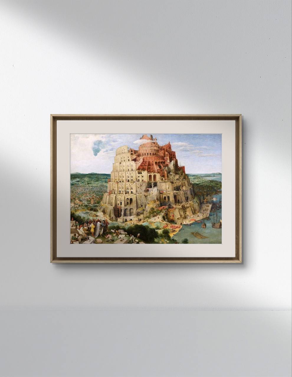 A minimalist interior setting with a light-colored wall and a framed poster of "The Tower of Babel" by Pieter Bruegel the Elder. The painting, a masterpiece from the Renaissance period, captures the grandeur and ambition of the biblical tower with its detailed depiction of the architecture and surrounding activities. This wall art is ideal for home decor, adding a sense of historical significance and artistic beauty to any room.