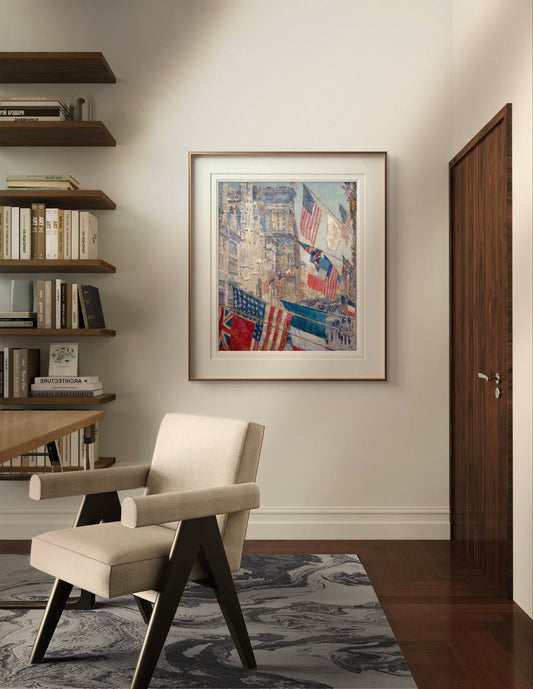 A contemporary home office with a beige chair, wooden shelves filled with books, and a framed poster of "Allies Day" by Childe Hassam on the wall. This painting, reflecting the vibrant Allies Day celebrations in New York City during World War I, adds historical depth and artistic charm to the room. Ideal for enhancing your home gallery wall or creating a lively atmosphere in any living space.