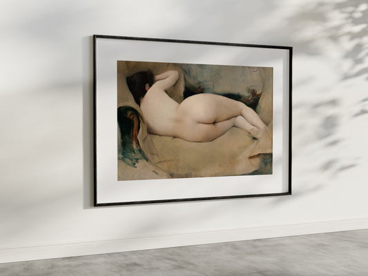 A refined presentation of "Nude Figure Study" by Ramon Casas, framed and displayed in a contemporary room with soft natural light. The painting, with its gentle portrayal of a reclining nude figure, uses a muted color palette to evoke tranquility and grace. This art reproduction enhances the aesthetic appeal of your living space, ideal for those who appreciate classic and serene artworks.