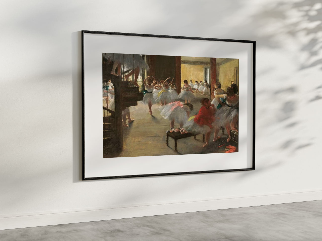 An elegant presentation of "The Dance Class" by Edgar Degas, framed and hung in a modern room. The artwork depicts ballerinas in a dance studio, captured in the midst of their exercises and practices, focusing on movement and grace. This art reproduction enhances the aesthetic appeal of any living space, perfect for ballet and classical art enthusiasts. Keywords: Wall Art, home decor, painting, art reproduction, famous artist, Poster, print, Edgar Degas, The Dance Class