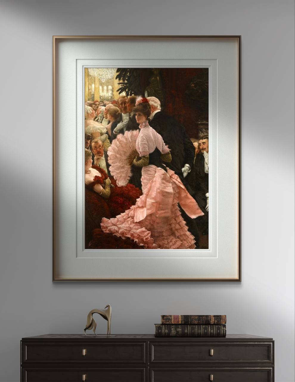 Vintage poster of "A Political Woman" by James Tissot, hung in a modern room with classic decor elements. The artwork features a woman in a pink dress, standing in a crowded and elegant social scene. The main colors are pink, red, black, and gold. This art reproduction brings a touch of elegance and sophistication to any home decor. Keywords: Wall Art, home decor, painting, art reproduction, famous artist, Poster, print, James Tissot, A Political Woman.