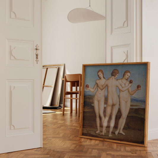 The third image features the "Three Graces" painting by Raphael framed and hung on a white wall. The minimalist gold-edged frame enhances the timeless beauty of the artwork. The high-quality reproduction captures the delicate details and harmonious composition of Raphael’s original, making it a striking addition to any decor.