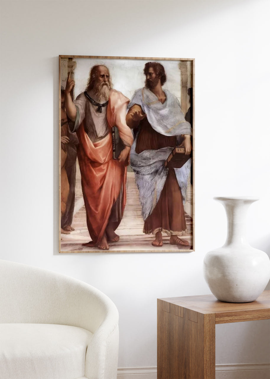 A detailed section of Raphael's "The School of Athens" is framed and displayed in a modern living room. The artwork stands out, adding intellectual charm to the room's contemporary decor, which includes a stylish chair and a side table with a vase.