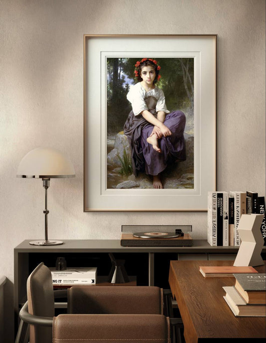 The framed painting of the young girl, captured in a quiet moment by the brook, hangs on a minimalist white wall. The white and gold frame enhances the delicate, natural tones of the artwork.