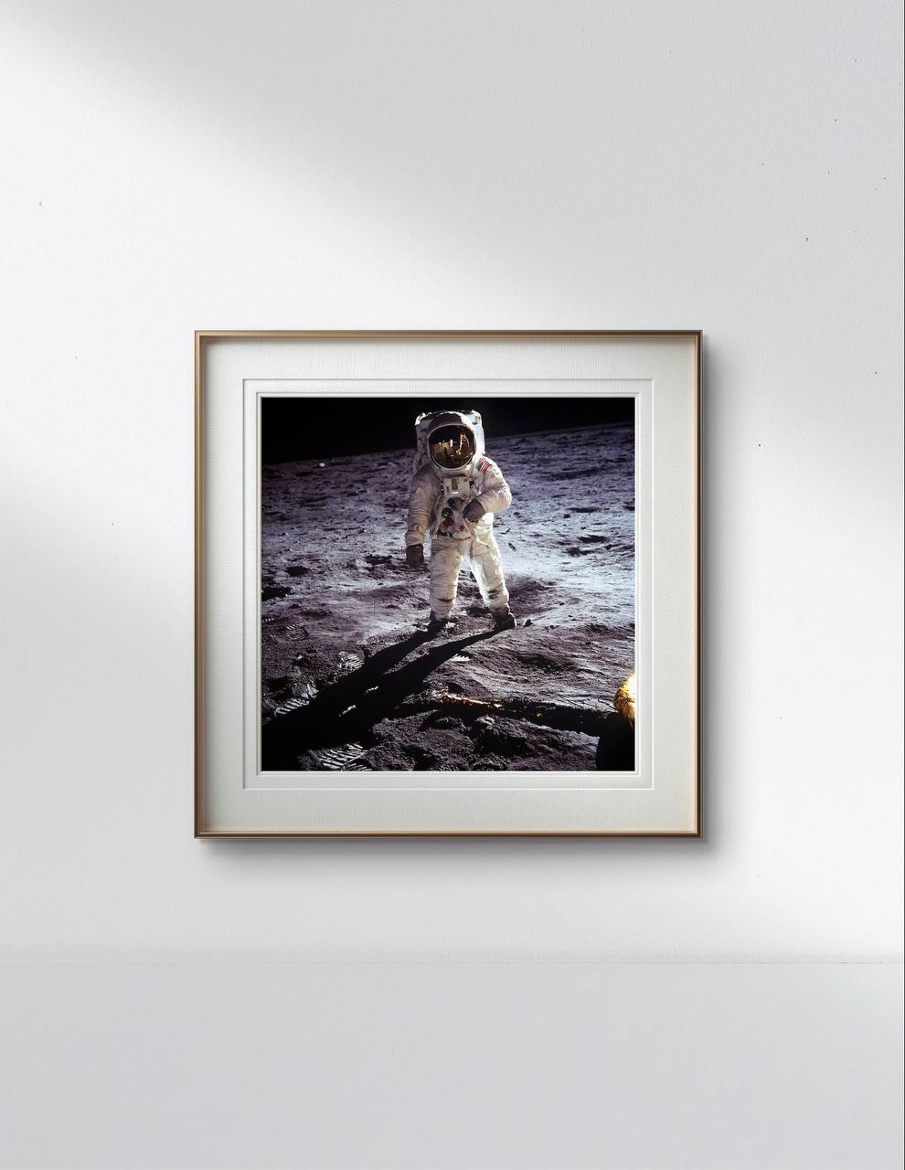 This framed poster of Buzz Aldrin on the moon brings a powerful historical moment into a sophisticated, modern interior. The soft, ambient lighting of the room contrasts with the dark void of space captured in the poster, making it a focal point of the decor. The image’s quality and the fine details of the lunar surface make it an excellent choice for a Home Gallery Wall or as a unique piece of Room Decoration. Ideal for space enthusiasts, this poster also makes for a remarkable Housewarming Gift or a spec