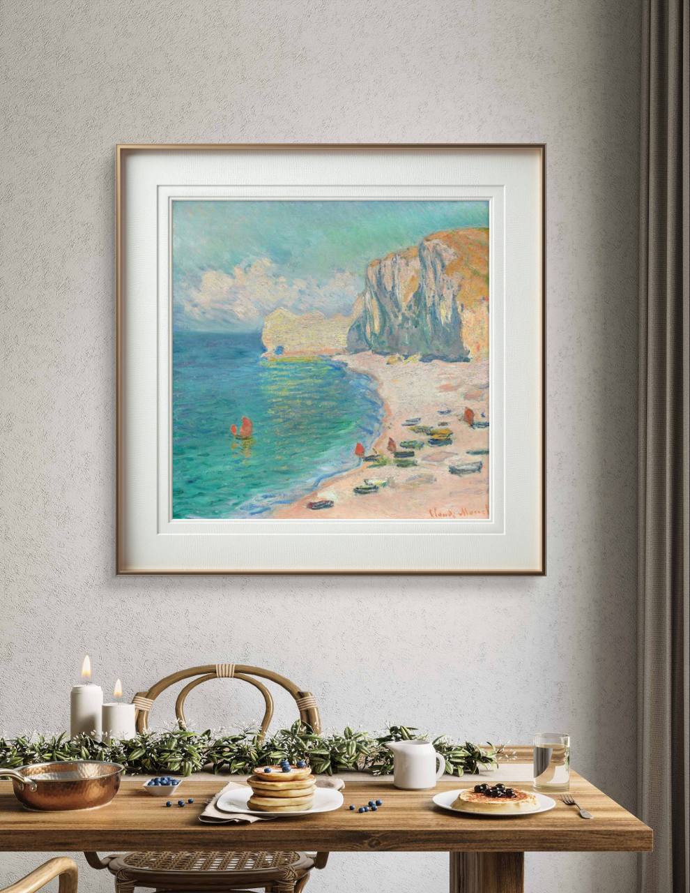 The Monet painting is elegantly framed and hung on the wall above a dining table decorated with white candles and a festive arrangement of green leaves. The artwork adds a serene and elegant touch to the space, with its soft colors contrasting against the wood tones in the room.