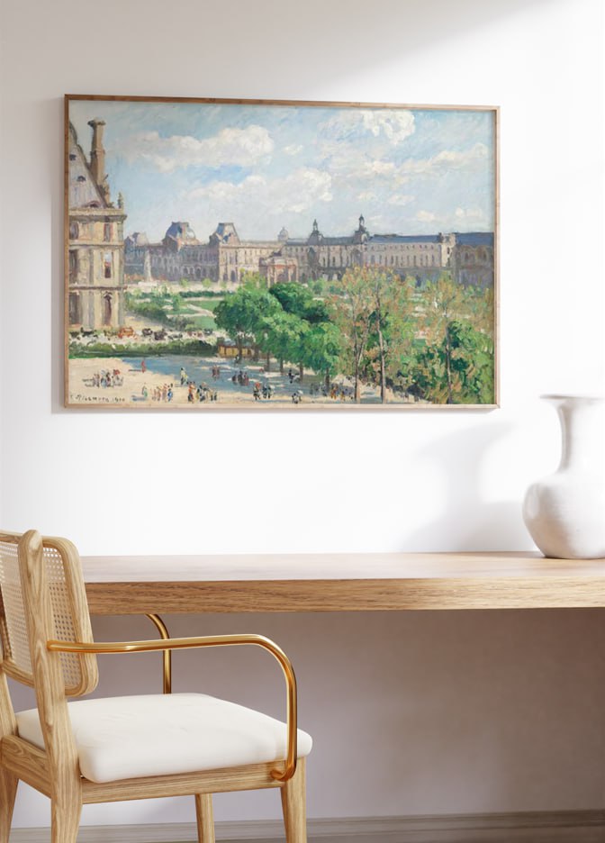Framed artwork of a bustling Parisian square on a sunny day, with lush trees and historic architecture. The painting adds a lively and classic touch to the elegant home workspace