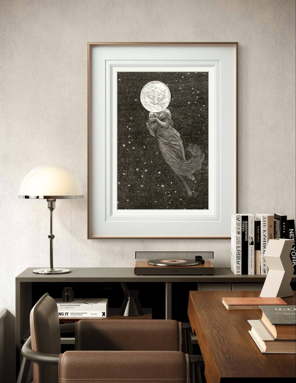 he framed artwork is shown hung on a modern, minimalist wall above a desk. The figure with the moon head floating in space adds a touch of mysticism and calm to the stylish workspace.