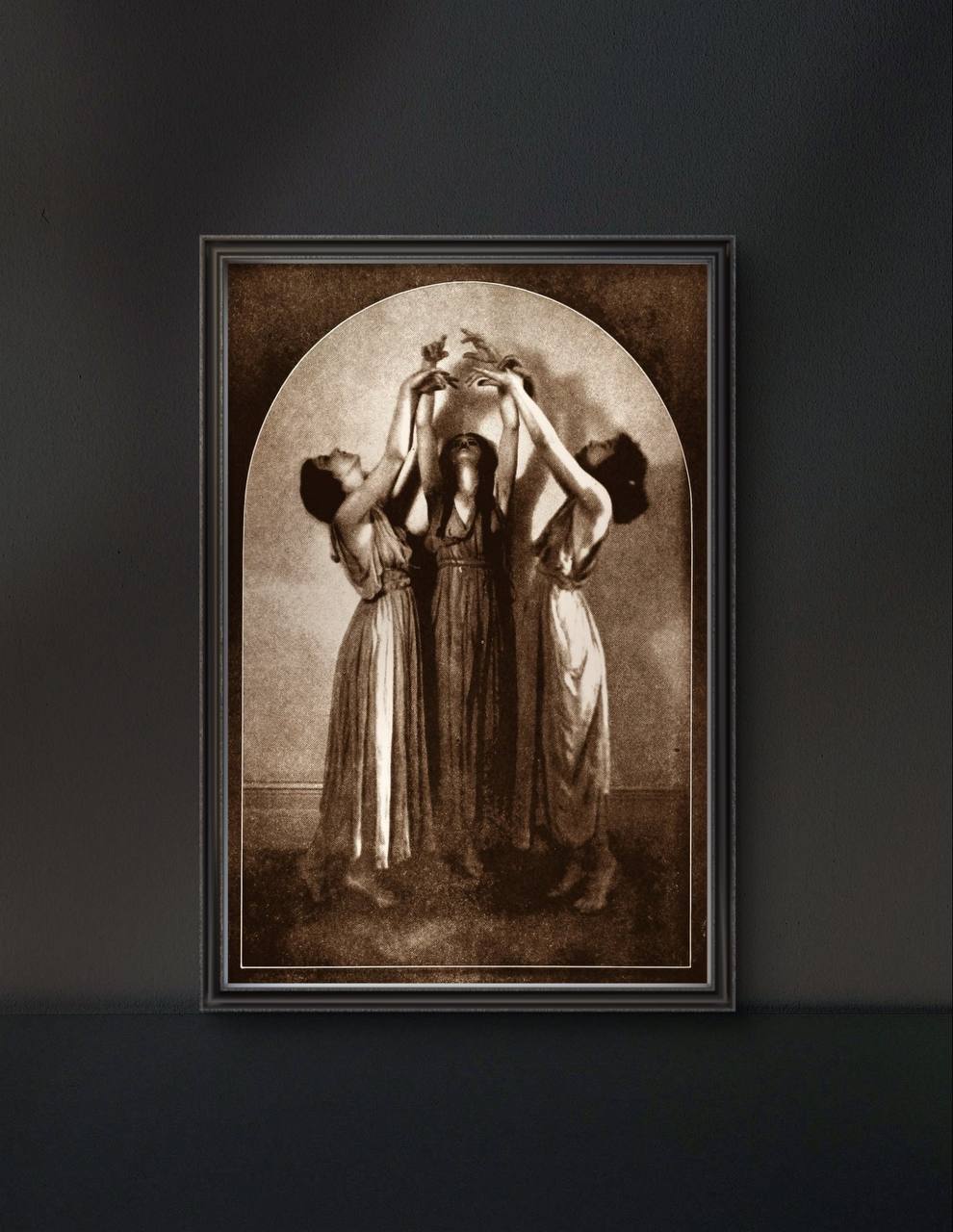 The framed artwork shows three women, their arms reaching toward the sky, in what seems to be a magical dance or ritual. The antique aesthetic adds a sense of ancient mysticism and grace to the room.