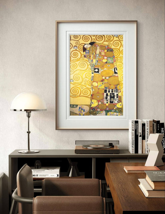 A framed painting of a loving embrace with gold spirals and geometric patterns. The figures are enveloped in a decorative cloak, bringing a warm and intimate mood to the modern, clean room decor.