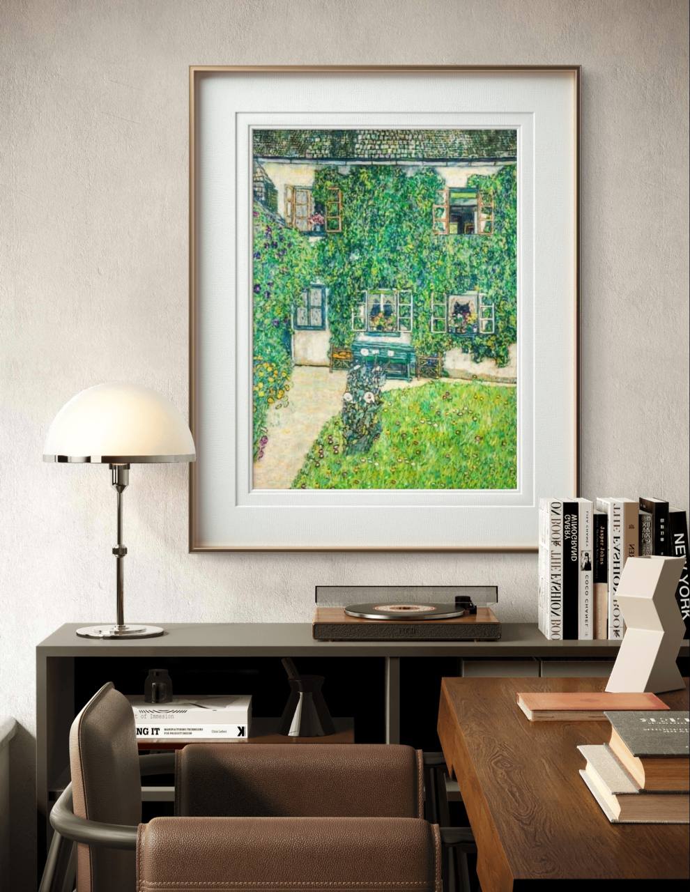 A framed painting of a house covered in ivy, with a green lawn in front. The artwork hangs above a modern desk, providing a fresh and tranquil atmosphere to the room's decor.