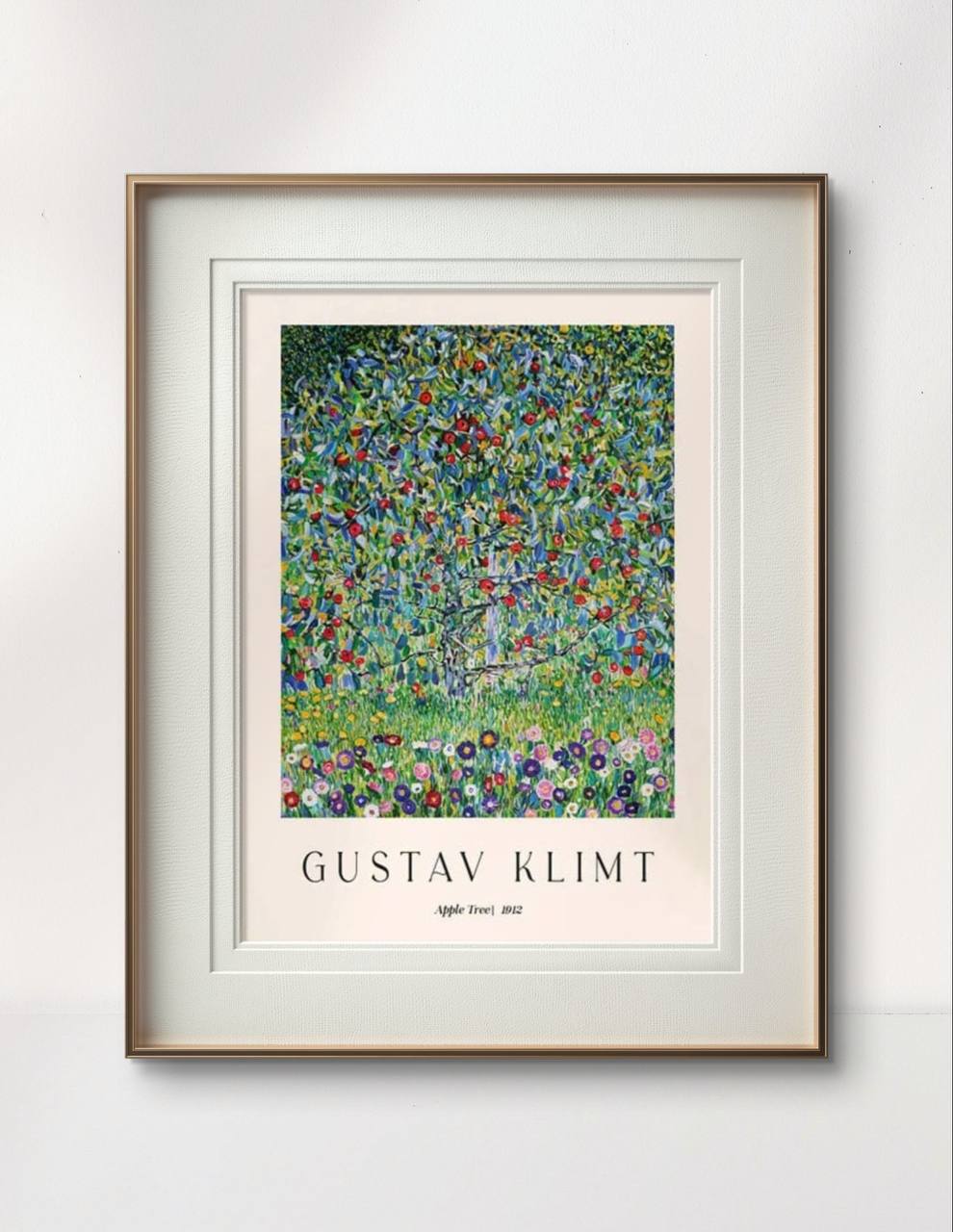 A framed poster of Gustav Klimt’s "Apple Tree," featuring a richly detailed tree covered in apples, surrounded by a colorful array of flowers. The bright greens and reds bring a burst of color to the minimal, neutral decor.