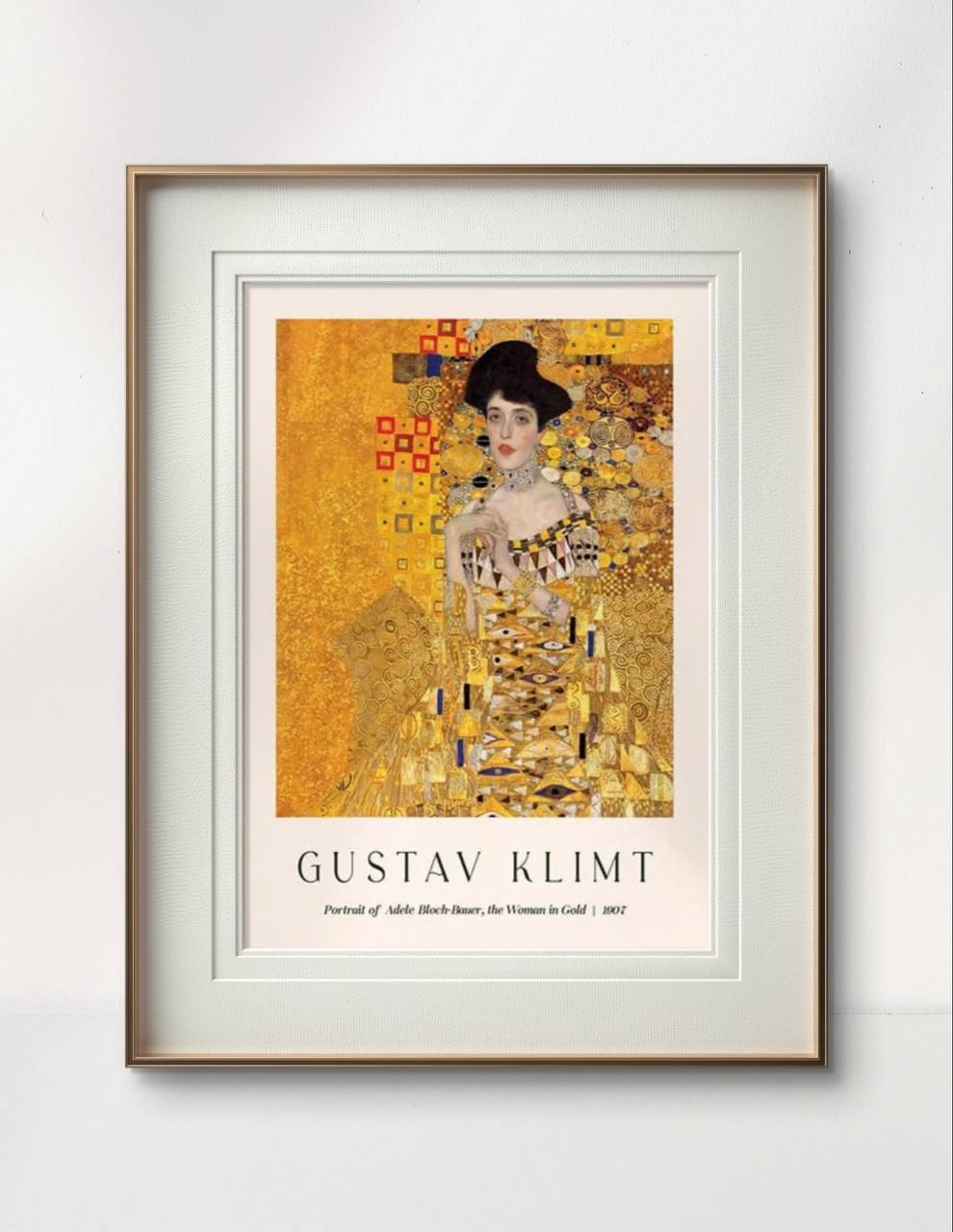 A framed poster of Klimt’s famous "The Woman in Gold," displayed against a light background. The intricate gold detailing and the regal pose of the woman bring an opulent and elegant touch to the minimalist room.