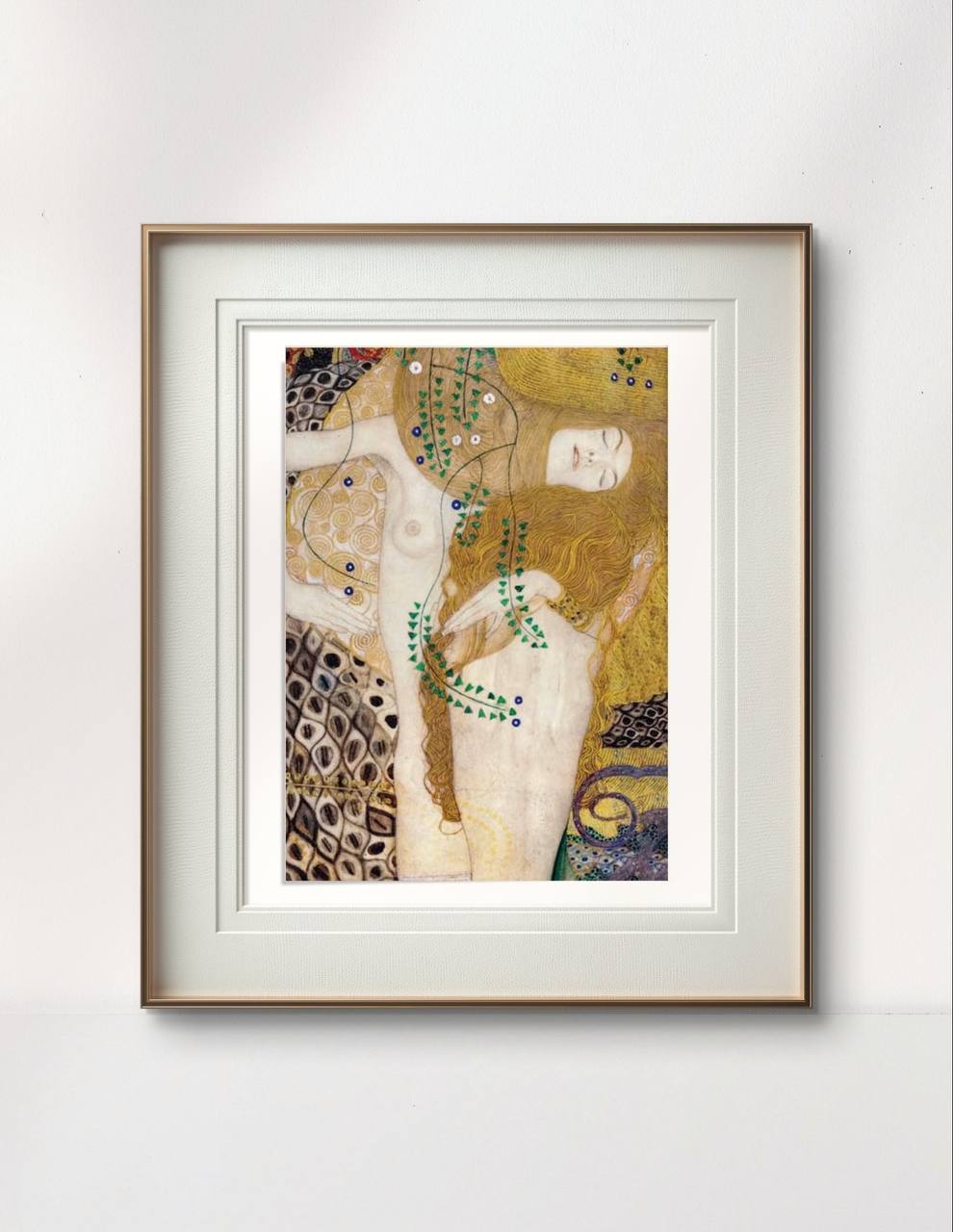 A framed painting of Klimt’s "Water Serpents I," showcasing two intertwined figures against a backdrop of intricate patterns and soft gold hues. The delicate curves and details create an ethereal and peaceful atmosphere.