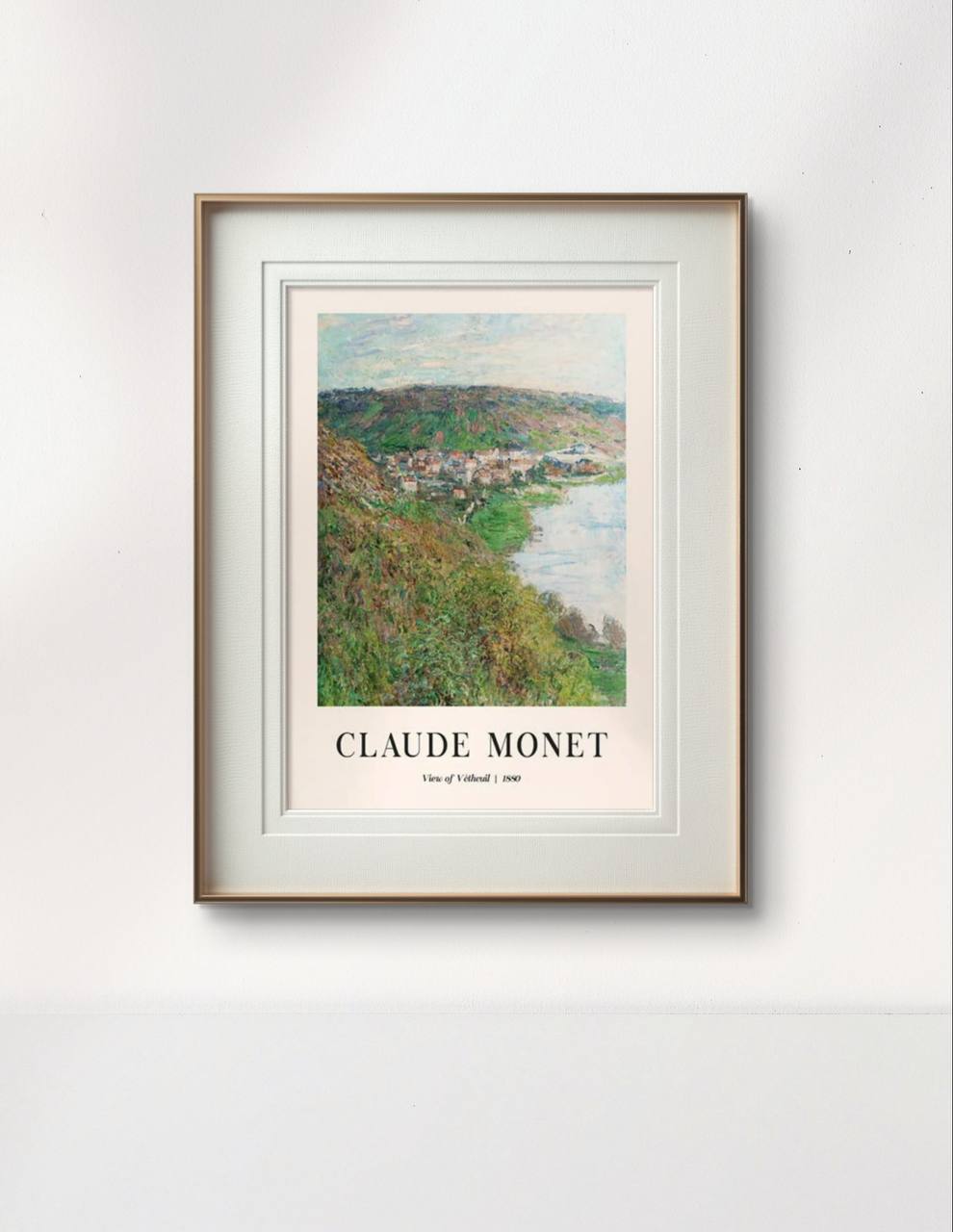 The framed painting captures a vibrant seascape with steep cliffs descending into the ocean. The artwork's bright colors stand out in the elegant white frame, adding natural beauty to the minimalistic room setting.