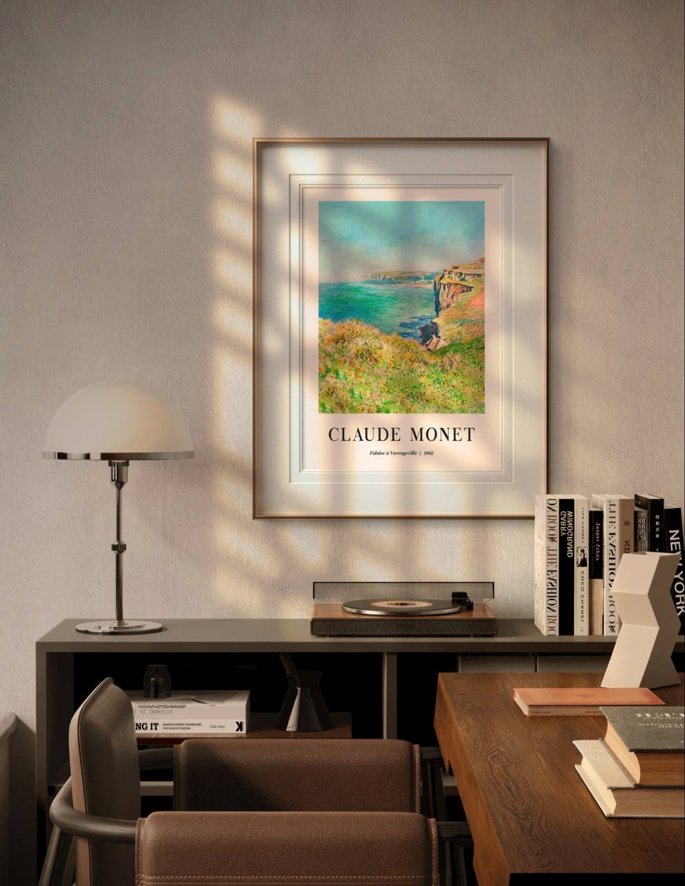 The framed painting captures a vibrant seascape with steep cliffs descending into the ocean. The artwork's bright colors stand out in the elegant white frame, adding natural beauty to the minimalistic room setting.