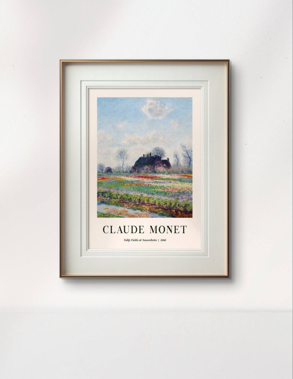 The framed artwork displays a charming house set against bright tulip fields. The mix of vibrant colors framed in a simple, elegant border brings a touch of the serene countryside to the room.