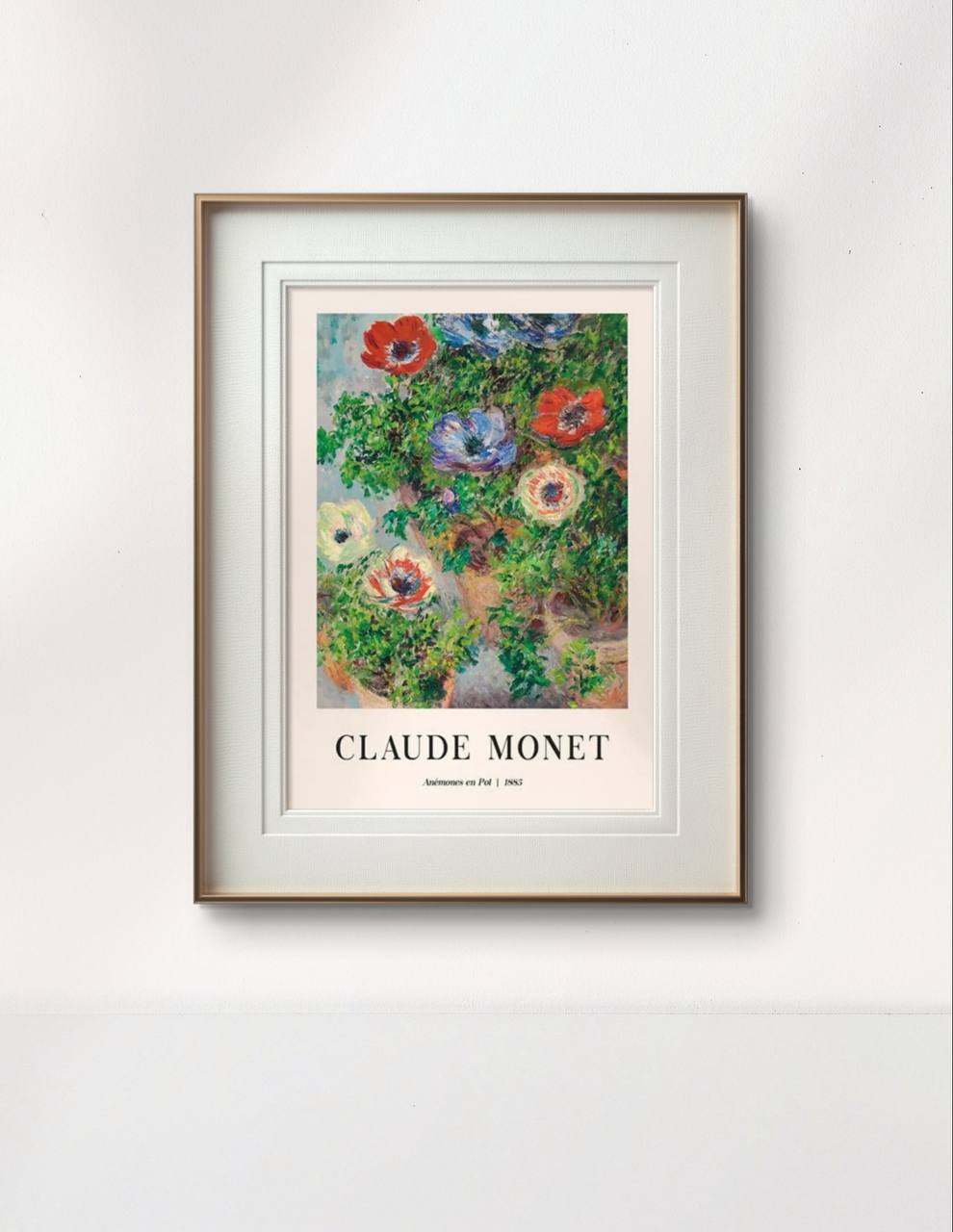 The same Claude Monet painting, elegantly framed and displayed on a white wall, showcasing bright anemone flowers in a minimalistic setting.
