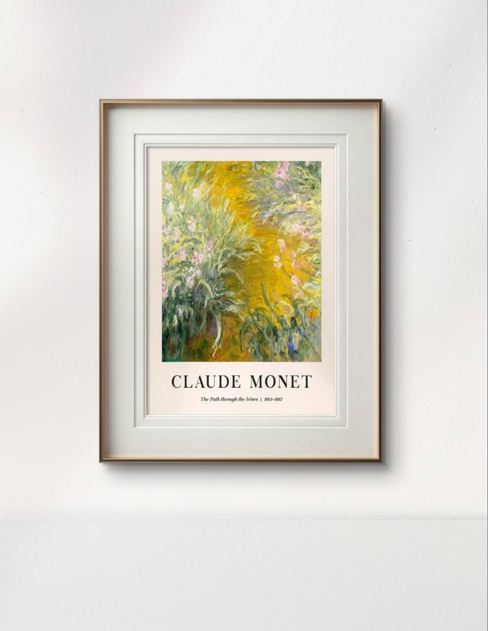The framed "The Path through the Irises" painting by Monet, featuring a lush garden scene with green and yellow hues, is displayed against a minimalist white wall, bringing nature indoors.