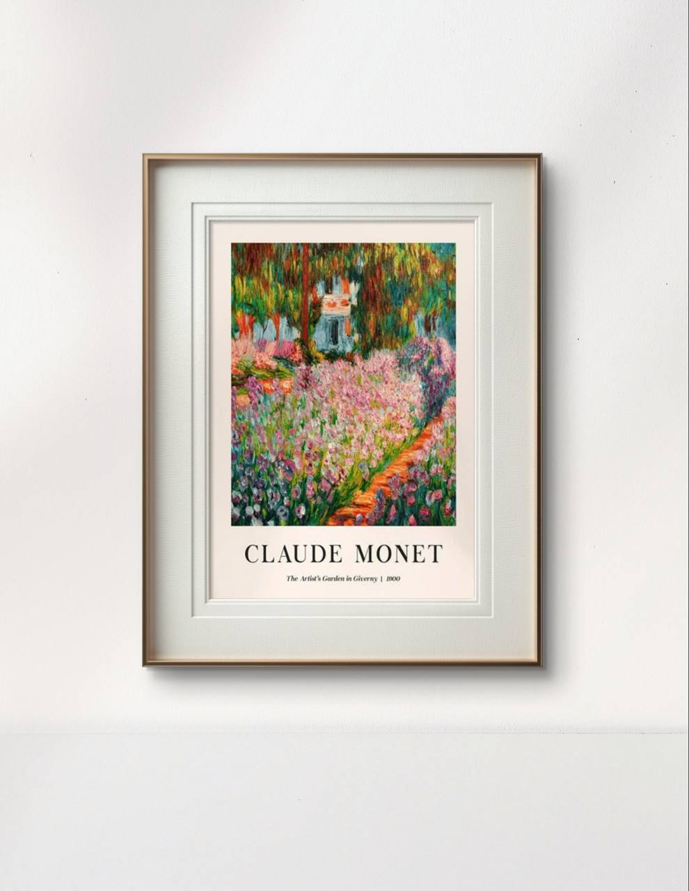 The framed Monet painting, "The Artist's Garden in Giverny II," is displayed on a white wall, showcasing colorful flowers and greenery, adding a lively and artistic touch to the space.