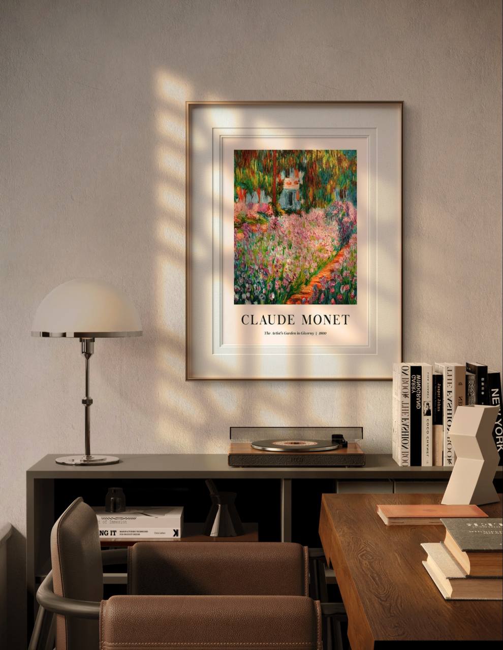 A framed Monet poster, "The Artist's Garden in Giverny II," hangs in a modern room above a desk. Sunlight streams in, illuminating the artwork and creating a peaceful, artistic ambiance.