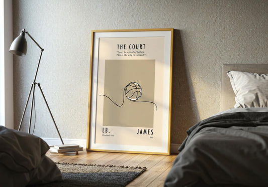 A minimalist line illustration of a basketball rolling across a court. The artwork is drawn with a single continuous black line on a beige background. A motivational quote above the ball reads: “Don’t be afraid of failure. This is the way to succeed.” The bottom of the poster includes the text “LB. James – Cleveland, Ohio – 2003.”