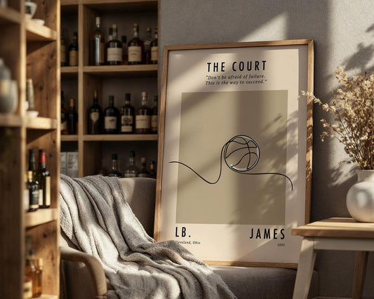 Framed poster with basketball design and text on a shelf with bottles and decor.