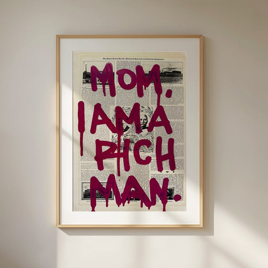 A vintage newspaper print with a black-and-white background, featuring a bold graffiti-style quote in dark burgundy letters reading “Mom, I Am a Rich Man.” The text appears to be dripping, mimicking spray paint, giving it an edgy street-art feel. The background contains old newspaper articles and a subtle portrait in the center, adding a vintage and artistic contrast to the modern graffiti typography.