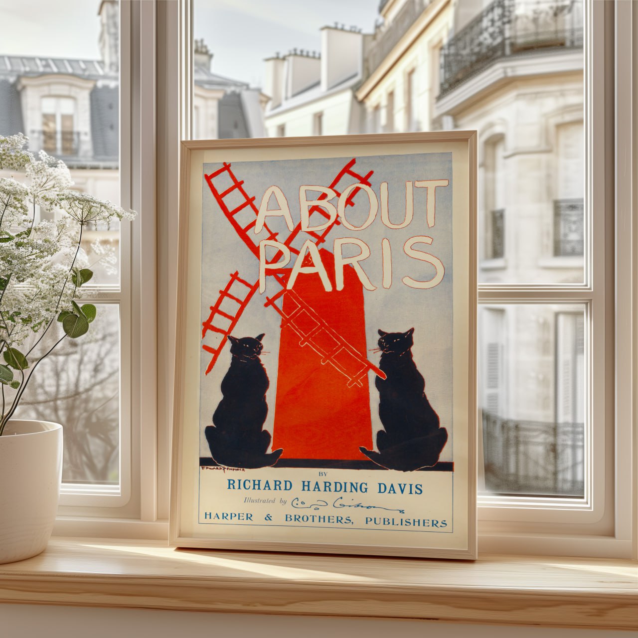 The image shows a poster or book cover titled "About Paris." In the center of the poster, there is a large illustration of two black cats, one on each side of a red windmill, which takes up a significant portion of the design