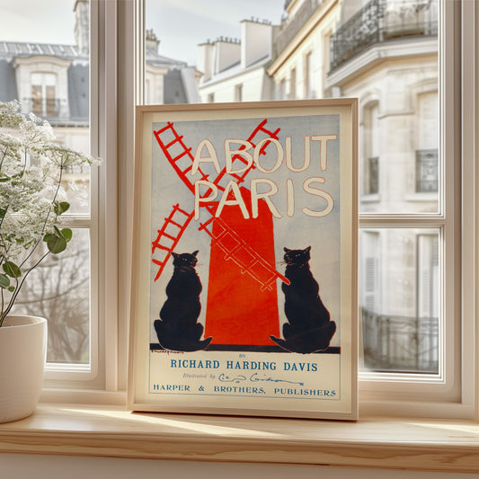 The image shows a poster or book cover titled "About Paris." In the center of the poster, there is a large illustration of two black cats, one on each side of a red windmill, which takes up a significant portion of the design