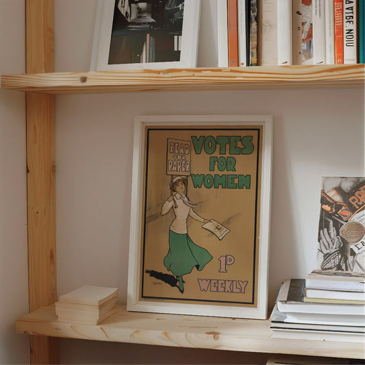 This image displays a vintage suffragette poster framed and positioned on a windowsill. The poster advocates for the women’s suffrage movement, encouraging readers to support the campaign for womens right to vote