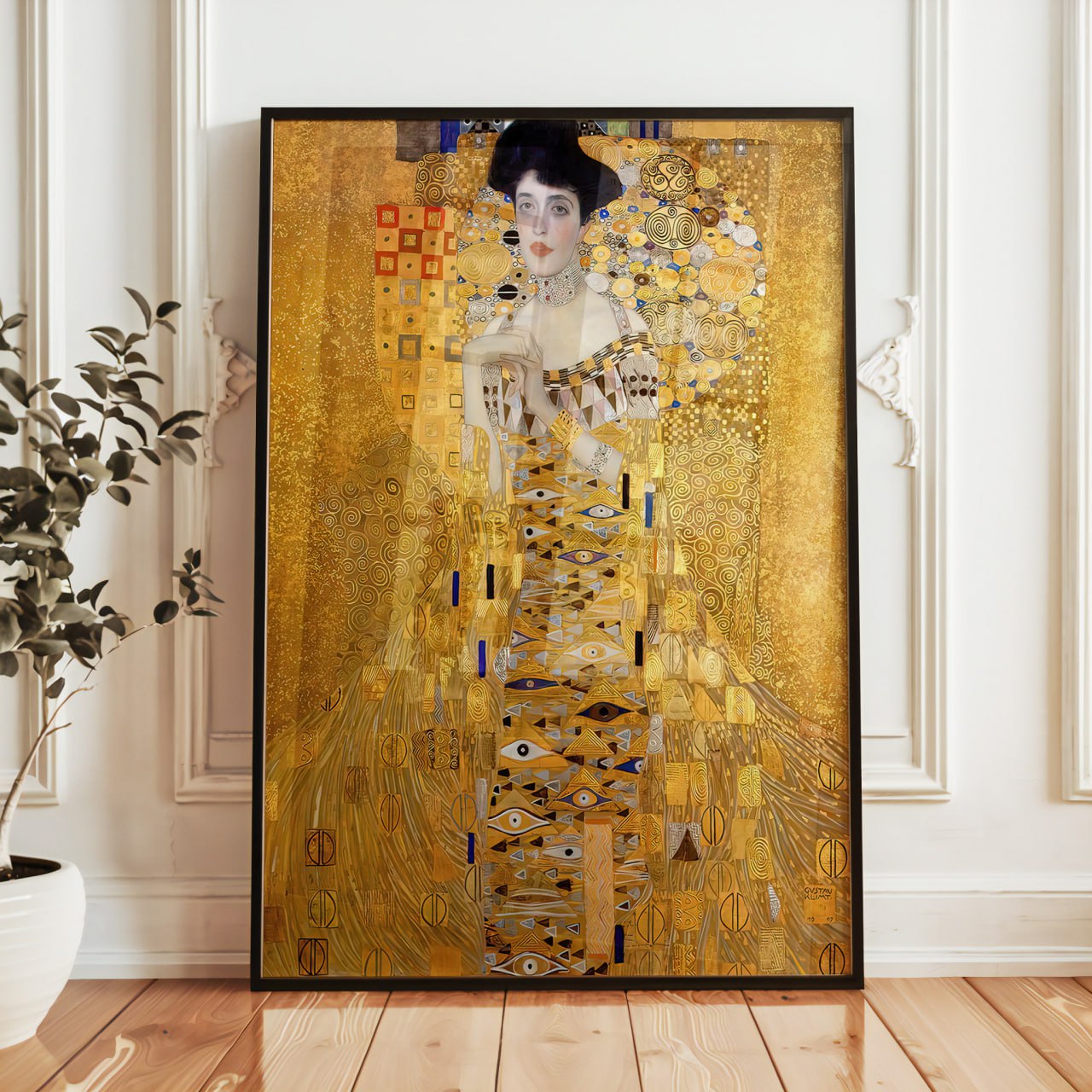 The image shows a framed reproduction of "Portrait of Adele Bloch-Bauer I", a famous painting by Gustav Klimt, resting on a wooden windowsill.