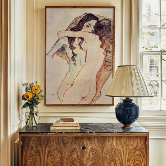 The drawing depicts two nude women embracing each other intimately. Their bodies are closely entwined, with one figure facing the viewer while the other has her back turned.