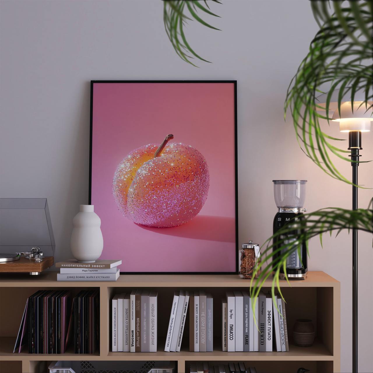 Framed artwork of a pink fruit on a shelf with books and decor items.