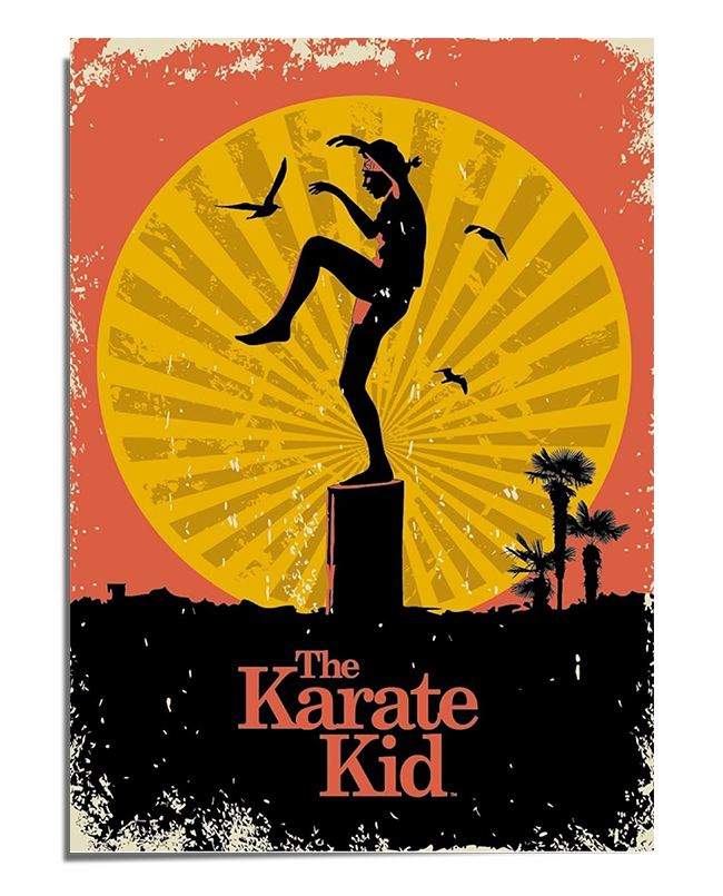 A vintage-style movie poster featuring the silhouette of Daniel LaRusso performing the famous crane kick on a wooden pillar, inspired by The Karate Kid. The background consists of a large, glowing yellow sun with radiating lines, set against a red-orange sky with distressed textures for a retro effect. Several birds fly across the scene, adding movement. Below, dark silhouettes of palm trees and rooftops complete the sunset setting. The title "The Karate Kid" appears in bold, classic typography at the botto