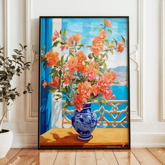 This poster depicts a vibrant Mediterranean scene with a close-up of bright orange bougainvillea flowers in a blue and white ceramic vase on a sunlit balcony. Behind, there’s a view of the sea and coastal mountains under a clear sky, evoking a serene and warm atmosphere.