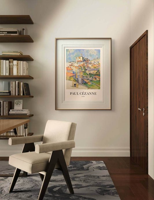 A minimalist interior space with a white wall and light wood flooring. The poster of "Gardanne" by Paul Cézanne is hung on the wall, framed and well-centered. Natural light softly illuminates the scene, highlighting the colors of the painting. This painting reproduction serves as excellent wall art for any home gallery wall or living space.