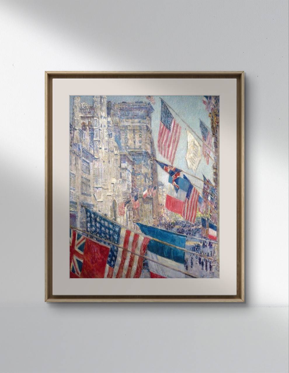 A framed poster of "Allies Day" by Childe Hassam displayed on a light-colored wall. The painting, created during the Impressionist period, showcases the festive celebration in New York City with colorful flags and detailed cityscapes. This wall art is ideal for home decor, adding a sense of historical celebration and artistic beauty to any room.