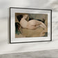 A refined presentation of "Nude Figure Study" by Ramon Casas, framed and displayed in a contemporary room with soft natural light. The painting, with its gentle portrayal of a reclining nude figure, uses a muted color palette to evoke tranquility and grace. This art reproduction enhances the aesthetic appeal of your living space, ideal for those who appreciate classic and serene artworks. 