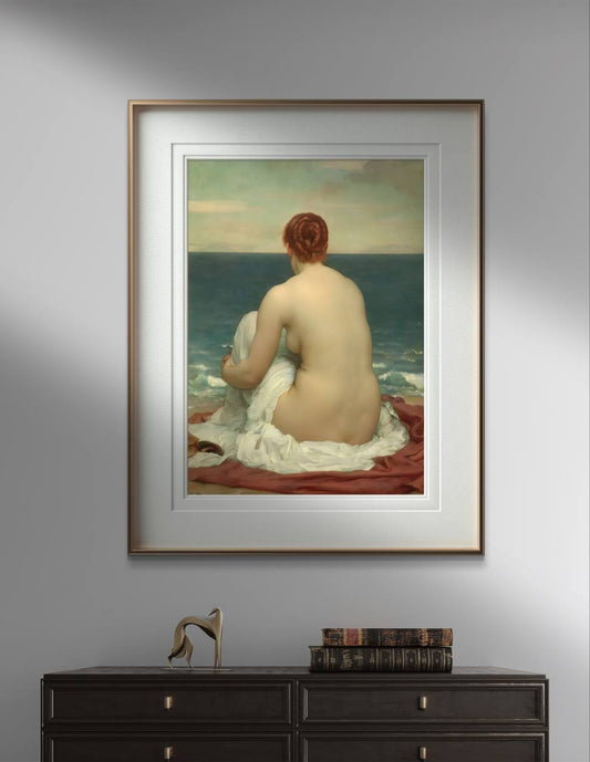 The first image features a framed poster of Frederick Leighton's painting "Psamathe" hanging on a gray wall. The artwork depicts a nude woman sitting on the shore, wrapped in a white cloth, gazing out at the ocean. The frame has a golden border, adding a touch of elegance. Below the poster, a modern workspace setup is visible, including books, and a turntable.