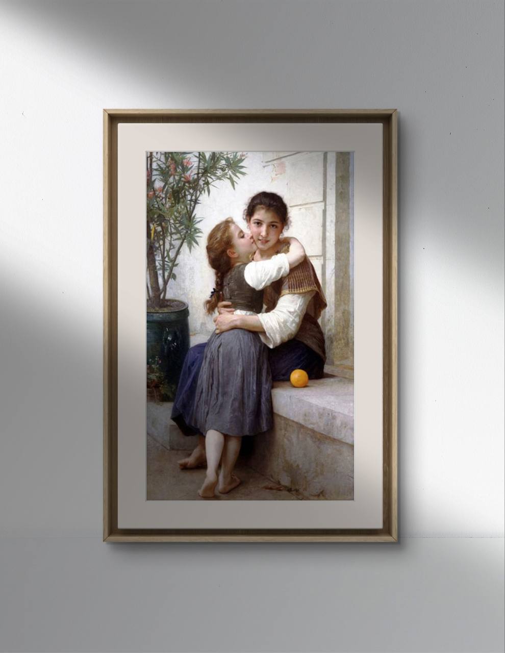 The first image shows a framed poster of William Bouguereau's painting "Calinerie." The artwork depicts a young girl embracing her older sister, who sits on a stone ledge. The older sister looks at the viewer with a gentle smile, while the younger girl rests her head on her sister’s shoulder. A potted plant and an orange on the ledge add to the serene setting. The poster is presented in a simple frame against a light background.