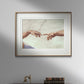 The third image features the "The Creation of Adam" hands poster by Michelangelo, framed and displayed above a dark wooden cabinet. The classic frame complements the detailed artwork, creating a sophisticated and timeless look. The iconic image of the almost-touching hands brings a touch of Renaissance art to the modern decor setup