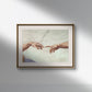 The second image shows the same "The Creation of Adam" hands poster framed and hung on a white wall. The classical frame and soft lighting emphasize the iconic moment captured by Michelangelo. The high-quality reproduction highlights the detailed depiction of the hands and the background, making it an elegant addition to any decor.