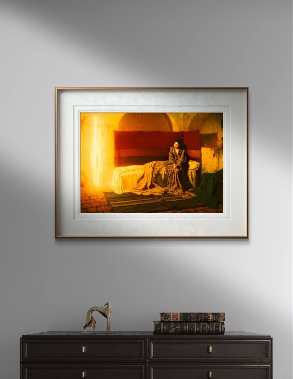 The second image shows the same "The Annunciation" poster framed and hung on a white wall. The elegant frame and gentle lighting emphasize the ethereal glow and emotional depth of the painting. This high-quality reproduction captures the intricate details and vibrant colors of Tanner’s original work, making it a beautiful addition to any room.