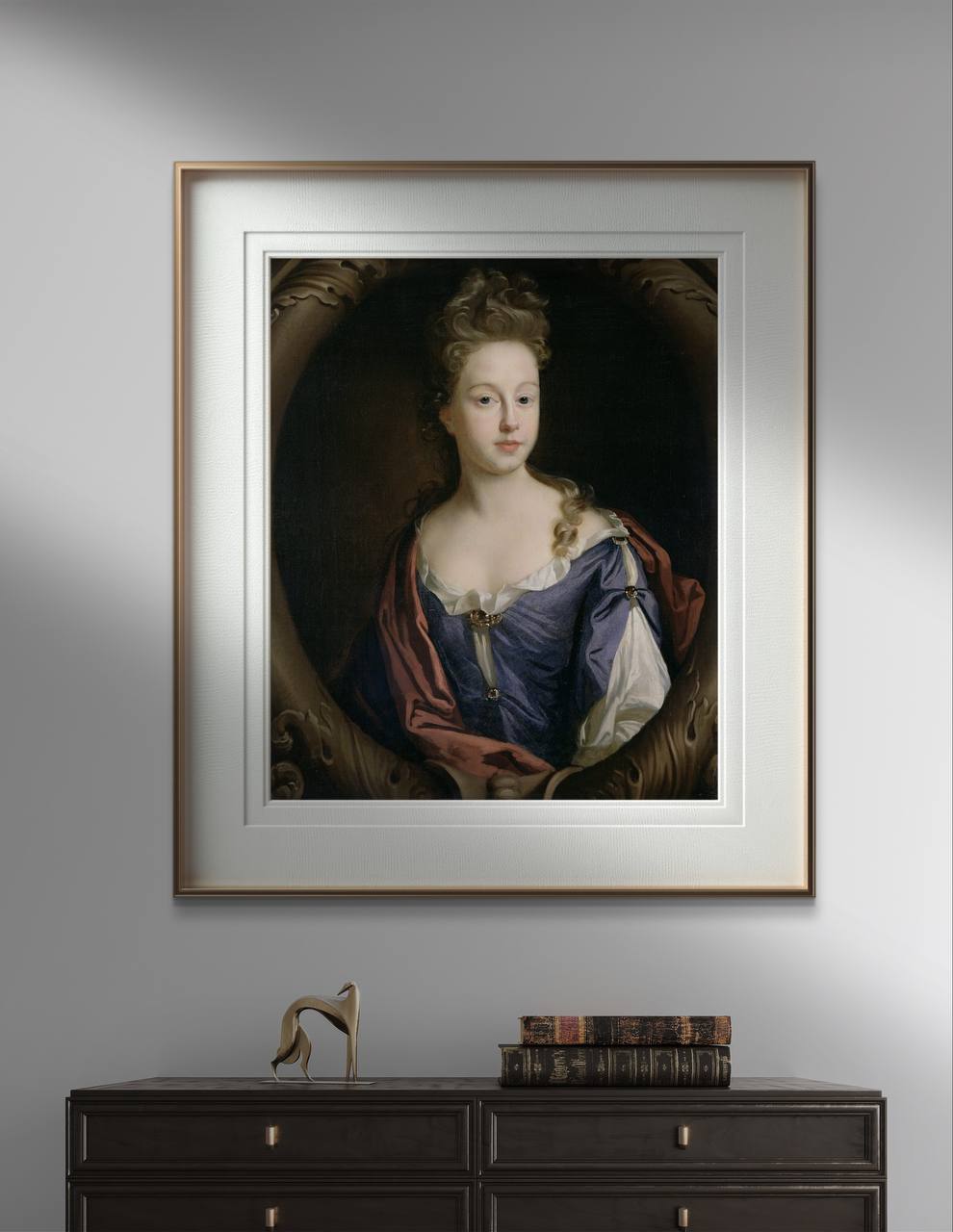 The second image presents the same framed poster of the elegant lady in a blue dress on a gray wall. The minimalist golden frame adds a touch of modern elegance to the Baroque art reproduction. Below the artwork, a dark wooden table with antique books and a modern sculpture creates a refined atmosphere.