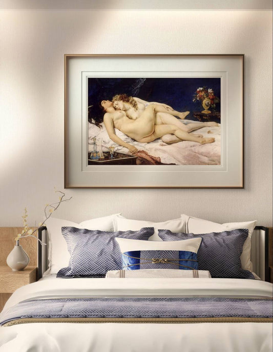 The painting of two reclining women is displayed above a bed with blue-patterned pillows. The soft lighting and elegant arrangement create a peaceful, intimate atmosphere in the bedroom