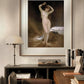 The framed painting of a nude woman is displayed in a cozy home office, above a dark wooden desk and bookshelf. Warm lighting and earthy tones in the room complement the artwork's serene beauty.