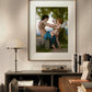 The framed painting of the woman and Eros is displayed in a warm home office. The decor includes a wooden desk, a modern lamp, and bookshelves, blending classic art with a modern interior design.