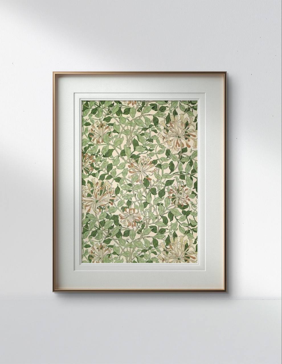 The framed William Morris print, showcasing a dense pattern of green leaves and flowers, is displayed in a sleek, modern room. The detailed artwork contrasts beautifully with the clean lines of the surrounding decor.