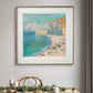 The Monet painting is elegantly framed and hung on the wall above a dining table decorated with white candles and a festive arrangement of green leaves. The artwork adds a serene and elegant touch to the space, with its soft colors contrasting against the wood tones in the room.